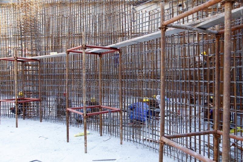 Builder Worker Knitting Metal Rods Bars into Framework Reinforcement