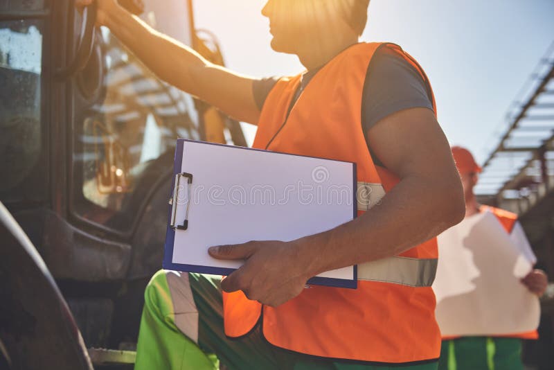 Builders in orange vests are working outdoor stock images Builders in orange vests are working outdoor stock images