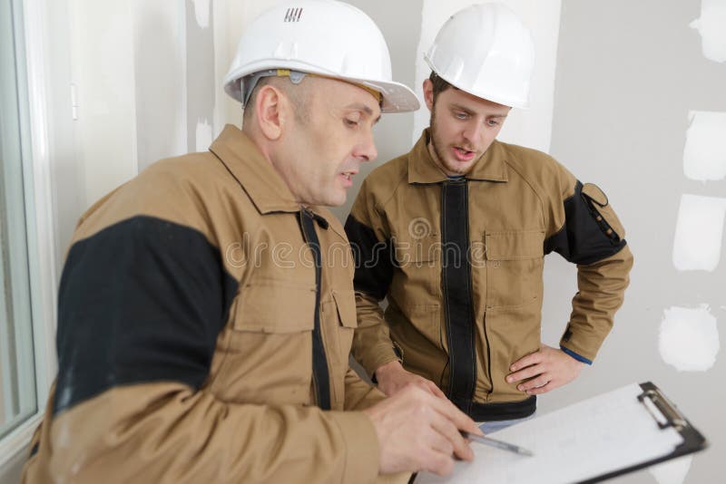 Builders Reading the Information Stock Photo Image of interior