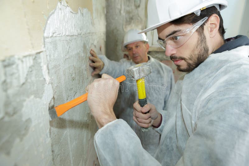 Builders Using Hammer To Remove Walls Plaster Stock Image Image of