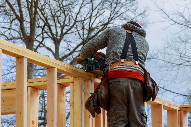 Builders on the Work Surface Using Circular Saw Cutting Wooden Boards
