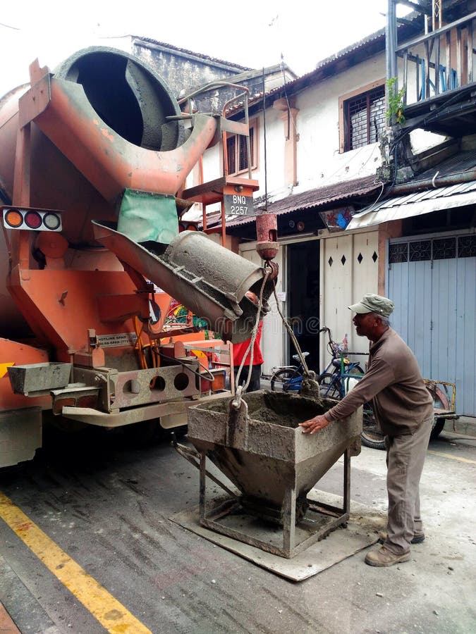 Building Construction Worker Pouring Cement Or Concrete With Pump Tube
