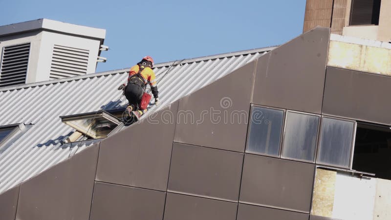 The building construction. The worker on the roof .