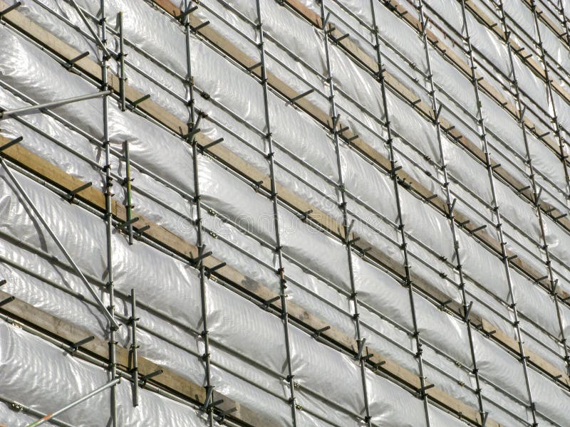 Building covered in white tarpaulin.