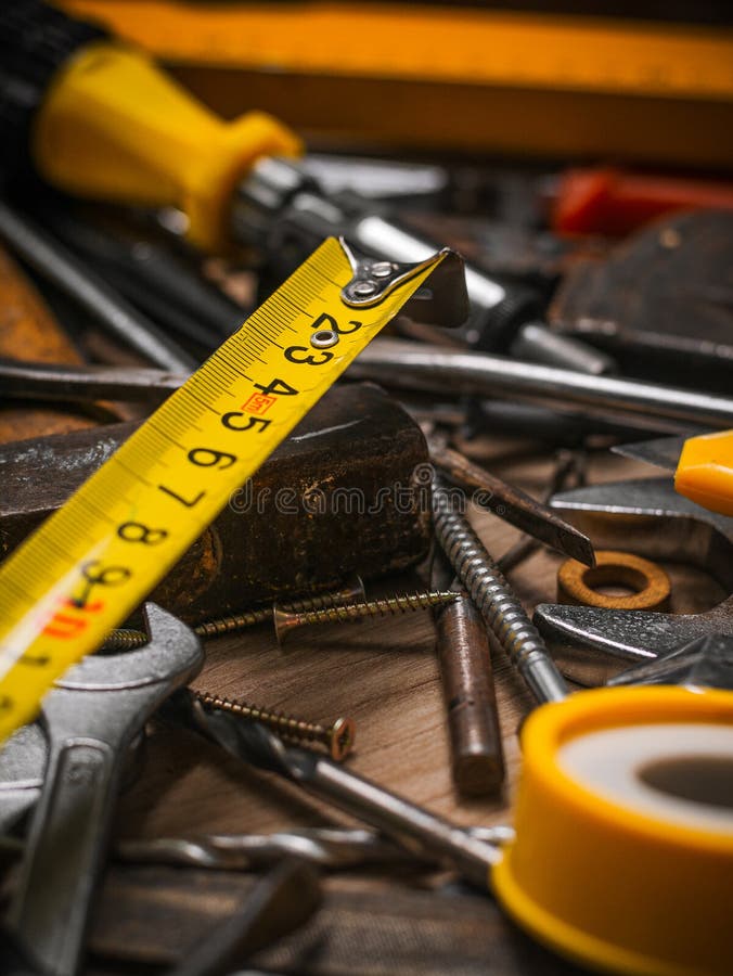Building and Measuring Tools. Set of Tools Over a Wood Panel Stock