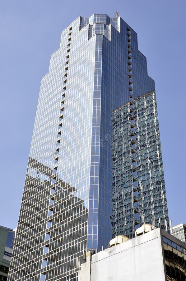 Blue Glass Skyscraper Soaring into Blue Sky Stock Image - Image of : A incredible picture capturing a stunning view. Its hues are striking and blend perfectly. The arrangement looks wonderful, and the details are also highly clear.