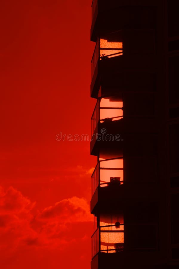 Building silhouette against a burning red sunset