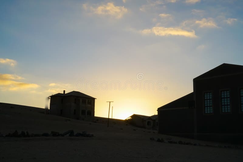 Building silhouette against sunset color sky