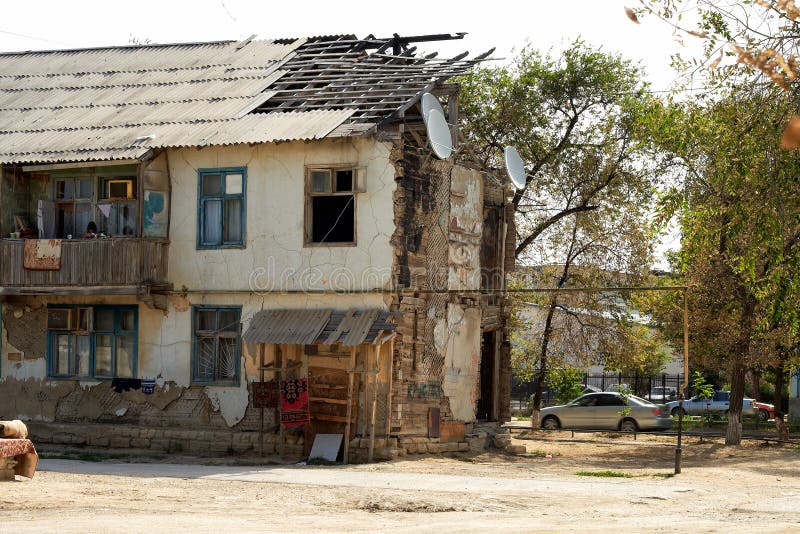 Double storey urban building with structural damage consisting of a stripped roof and sections of missing exterior walls as a result of severe weather awaiting repair and renovation