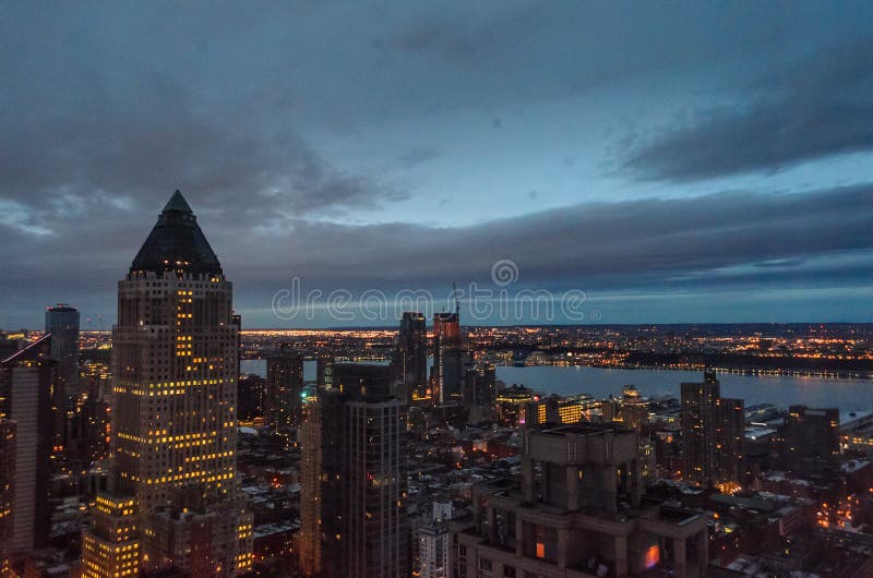 Buildings, Skyscrapers and Towers in New York at Night Time on a Cloudy Day of Winter. Hudson River and Jersey City in Background. Buildings, Skyscrapers and