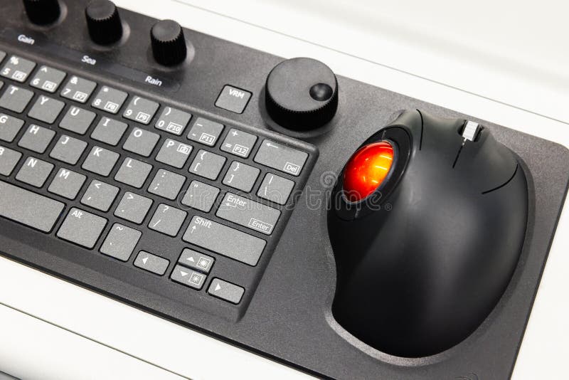 Built-in tabletop input device, black industrial keyboard with red trackball royalty free stock images