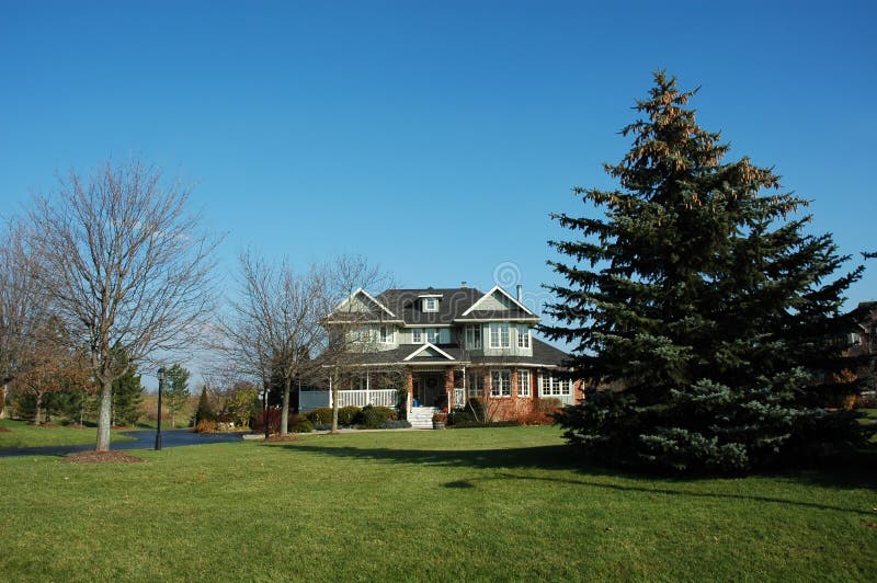 Country house with lots of acreage and porch and winding driveway. Country house with lots of acreage and porch and winding driveway