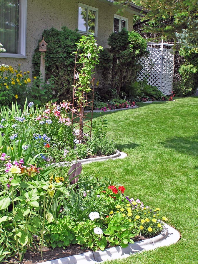 Sunny, side garden, curving perennial bed in July. Sunny, side garden, curving perennial bed in July.