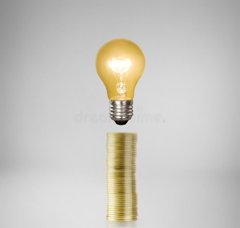 Bulb With Stack Of Coins stock image