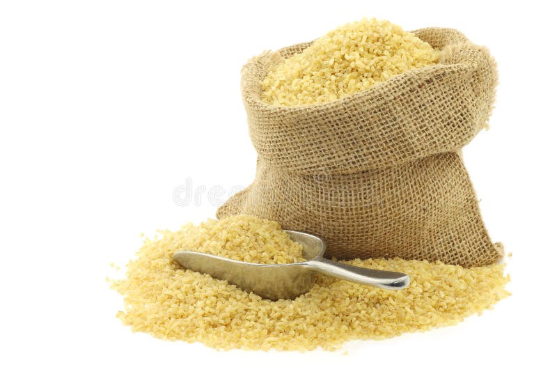 Bulgur (couscous) in a burlap bag with an aluminum scoop on a white background