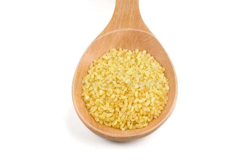 Bulgur (cracked wheat) and wooden spoon.