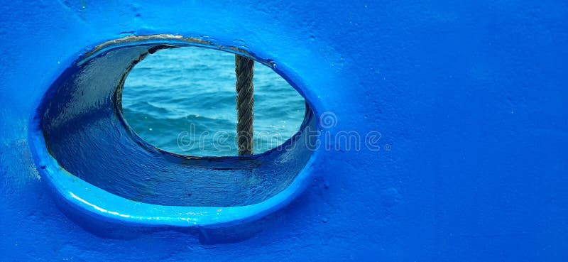 BullÂ´s eye, porthole, round window on a blue boat, ship, ferry