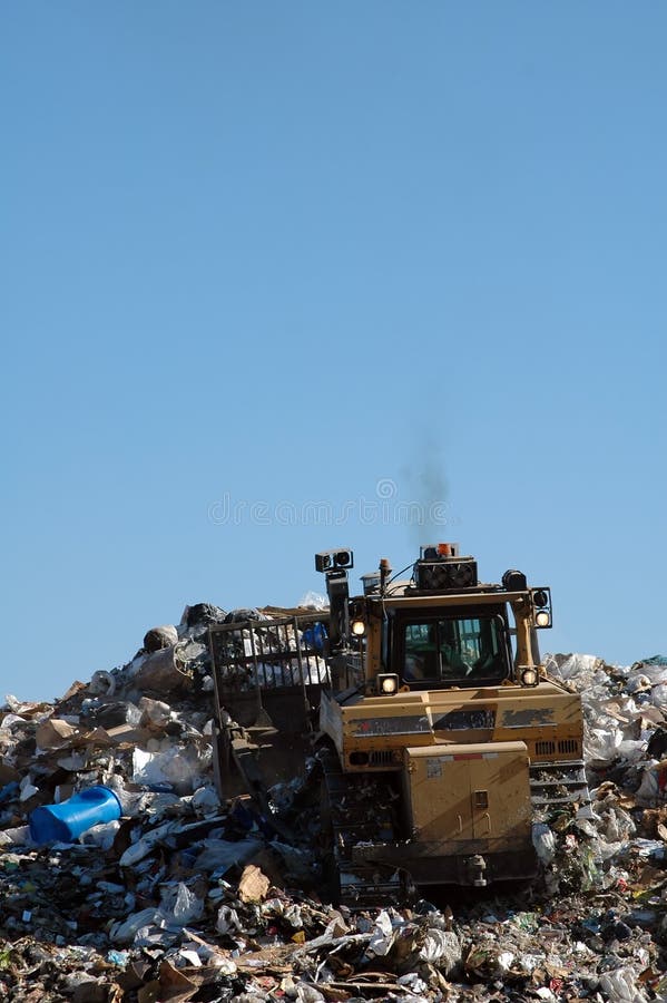 Dozer pushing trash at landfill. Dozer pushing trash at landfill