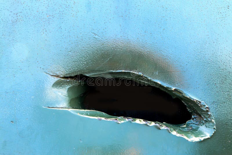The bullet hole in the armor of the tank stock images