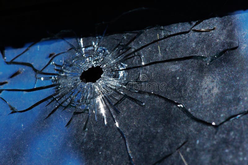 A bullet hole is in glass stock image. Image of aperture 17155607