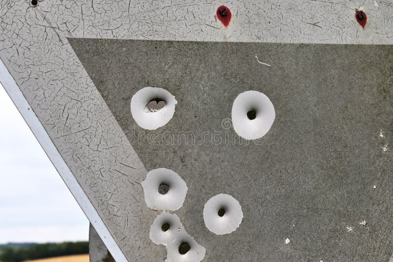 Bullet holes in a german traffic sign from a gun shooting exercise stock image Bullet holes in a german traffic sign from a gun shooting exercise stock image