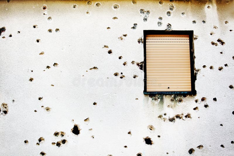 Bullet holes in a house facade