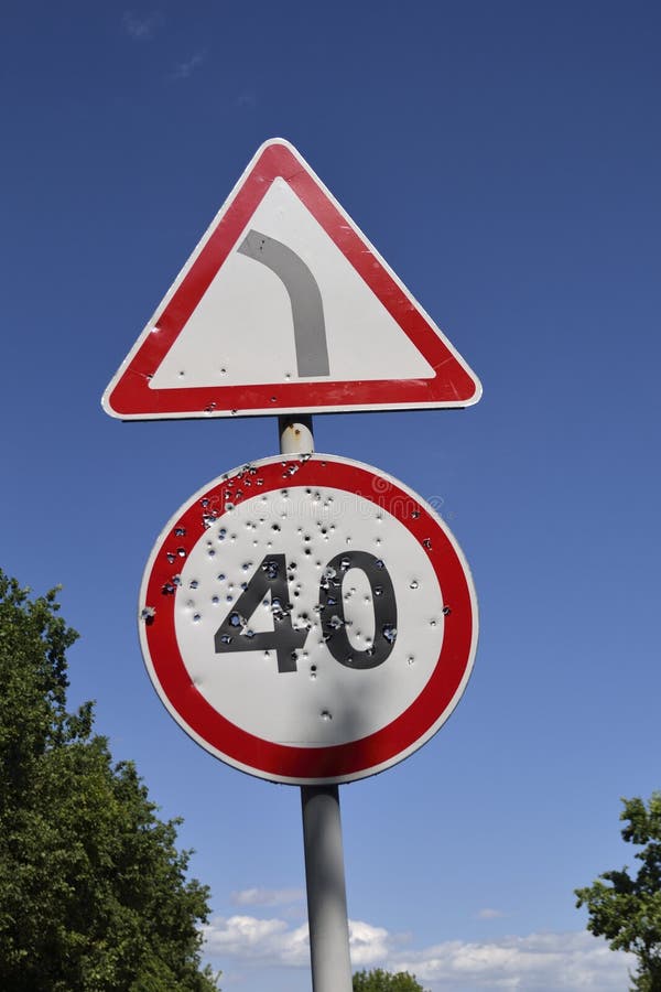 Bullet holes on the speed limit road sign. stock images