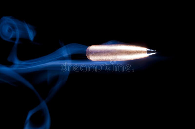Bullet and smoke on black stock photo
