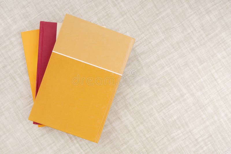 A bunch of books is on the table, yellow book, empty space, tex stock photos