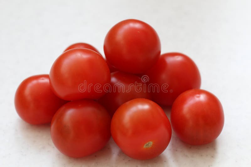 Bunch of Cherry red tomatoes isolated on table stock image Bunch of Cherry red tomatoes isolated on table stock image