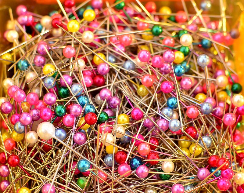 Heap of multi-coloured sewing pins on a white background, Stock image