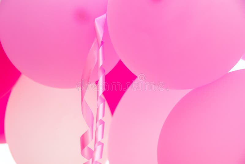 Shiny decorative ribbons hanging from helium balloons Stock Photo