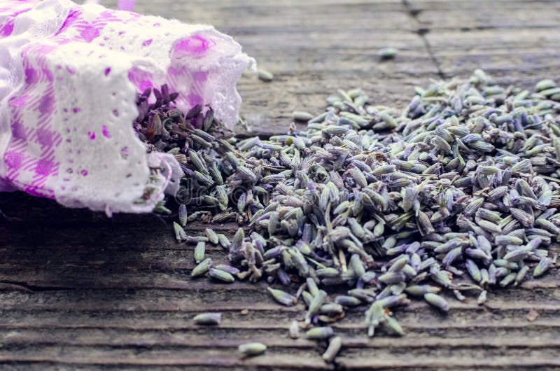 Bunch of lavender flowers and sachet filled with dried lavender on a wooden background. Top view