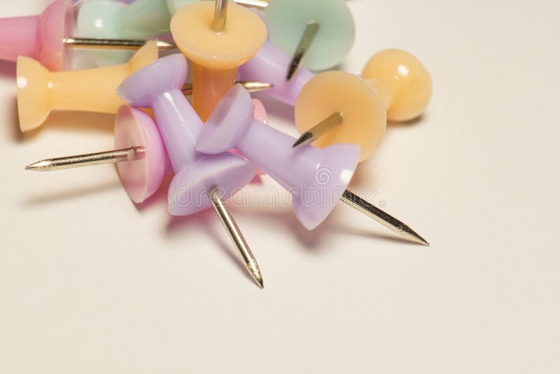 A bunch of multicolor bright pins on paper, soft focus