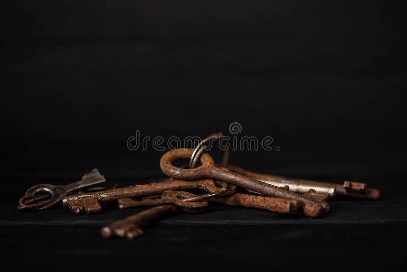 Bunch of old metal keys on a table, low key. Theme of collecting, vintage decoration, safety concept royalty free stock photos Bunch of old metal keys on a table, low key. Theme of collecting, vintage decoration, safety concept royalty free stock photos