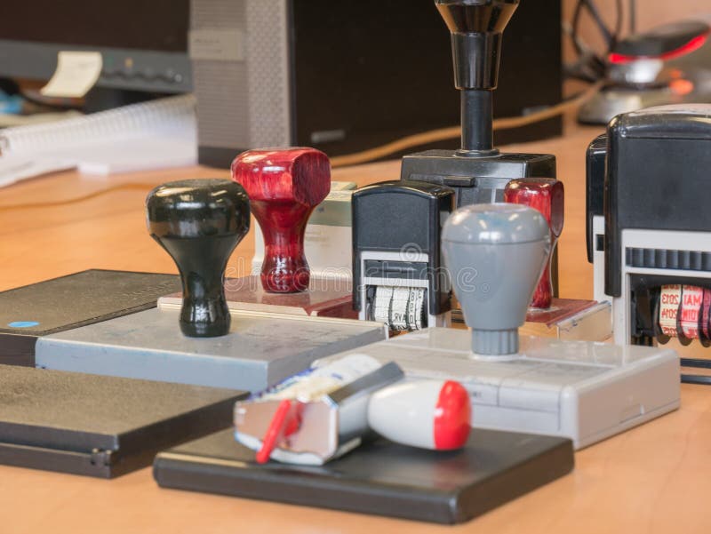 Bunch of old office stamp on a desk stock photos