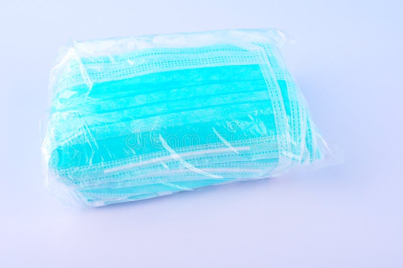 Bundle of Surgical Face Mask in Plastic on White Table Stock Image