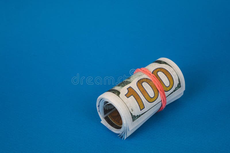 bundles of twisted money of different currencies on a blue background stock image bundles of twisted money of different currencies on a blue background stock image