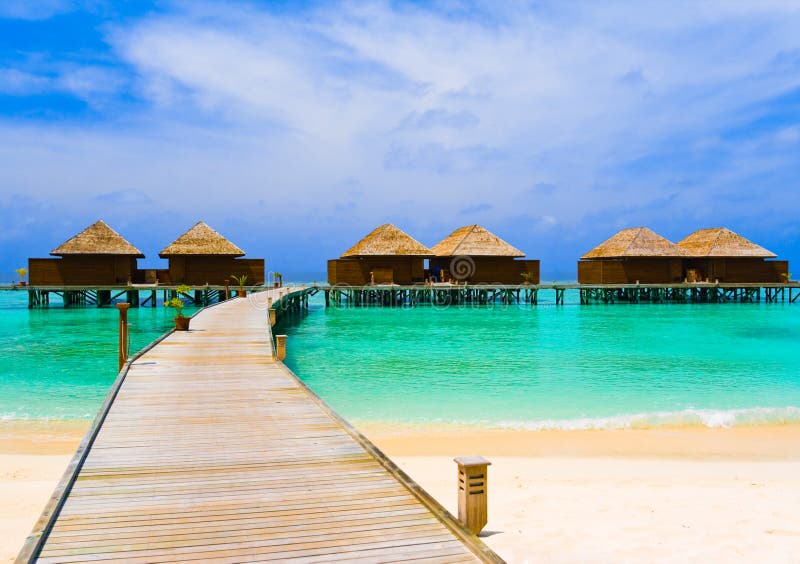 Water bungalows at a tropical island - travel background. Water bungalows at a tropical island - travel background