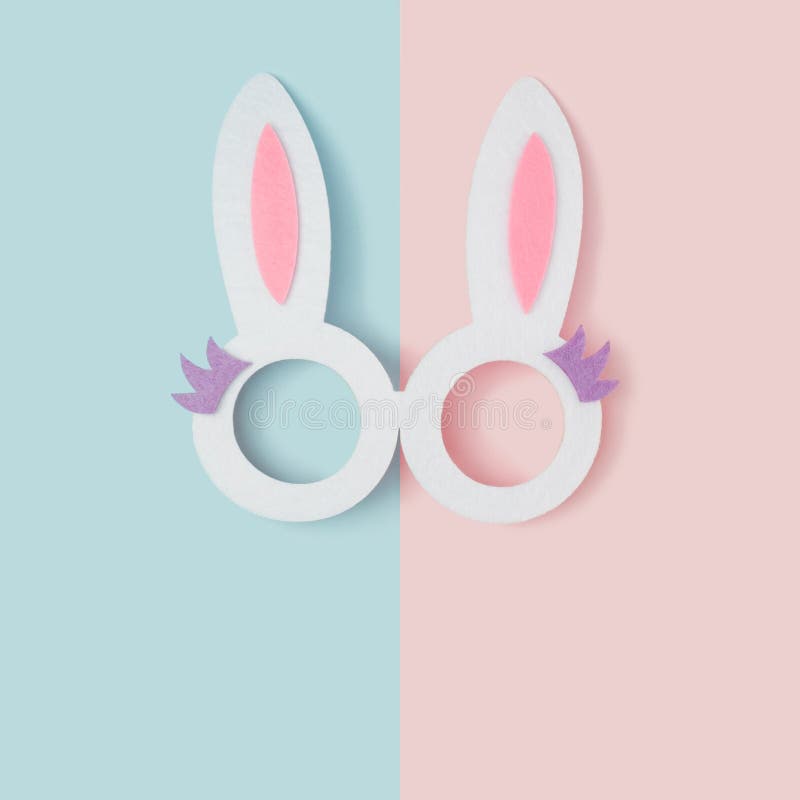 Bunny ears glasses on a two tone pastel background. Happy Easter minimal concept