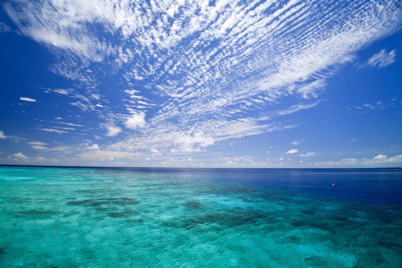 Colorful turquise ocean and sliding clouds in deep blue sky. Colorful turquise ocean and sliding clouds in deep blue sky.