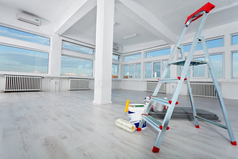 Newly renovated generic empty office space with leftover materials and ladder in foreground. Newly renovated generic empty office space with leftover materials and ladder in foreground