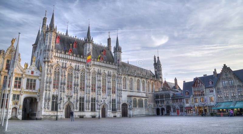 BRUGGE, BELGIUM - SEPTEMBER 17, 2014: The Burg square and facade of gothic town hall. BRUGGE, BELGIUM - SEPTEMBER 17, 2014: The Burg square and facade of gothic town hall.