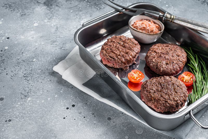 Burger Beef Meat Steak Patties with Herbs. Gray Background. Top View