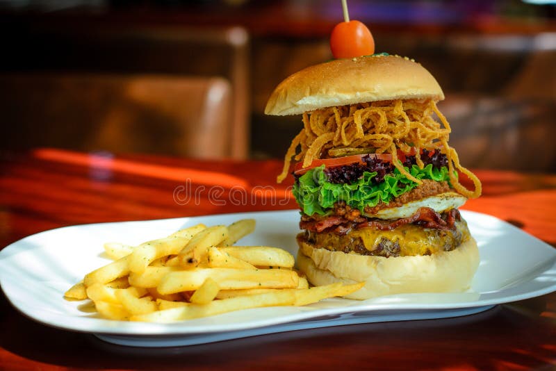 A Burger with Beef Patty and Bacon and Cheddar Cheese and Egg, Chilli