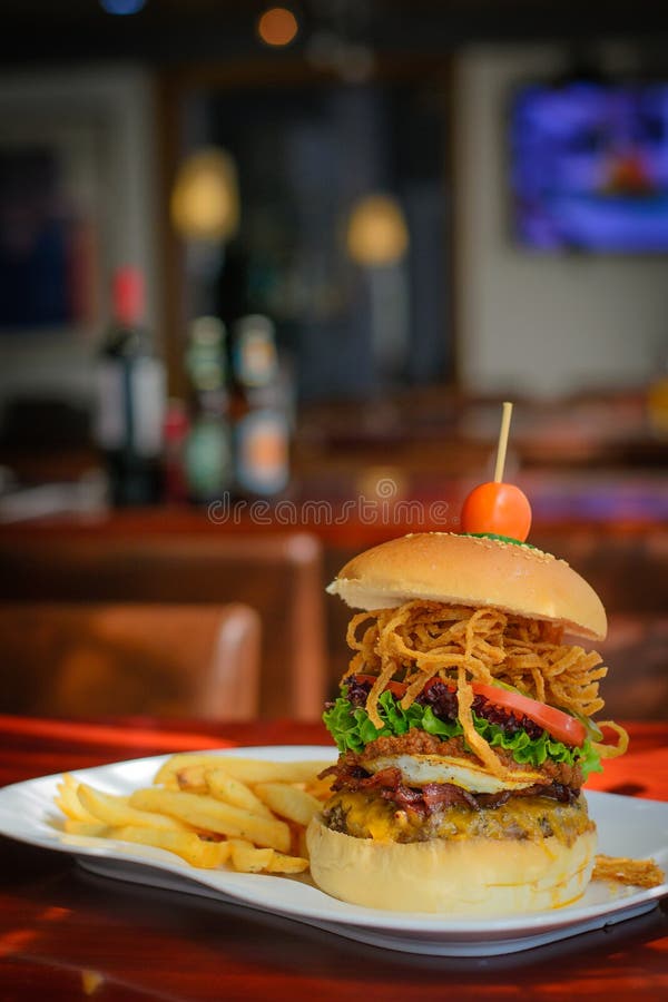 A Burger with Beef Patty and Bacon and Cheddar Cheese and Egg, Chilli