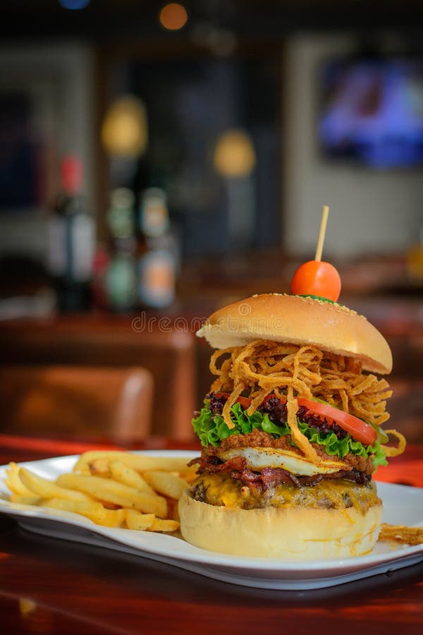 A Burger with Beef Patty and Bacon and Cheddar Cheese and Egg, Chilli