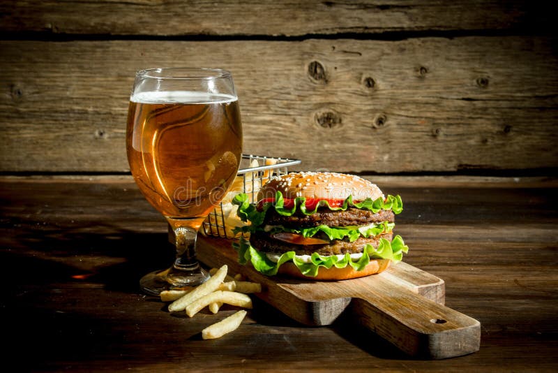 Burger with beer in a glass and fries