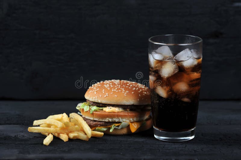 Burger with french fries and a glass with ice cola