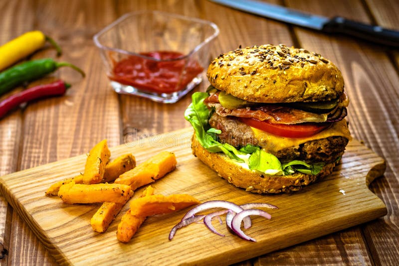 Burger with Sweet Potato Fries Stock Photo - Image of tomato, table
